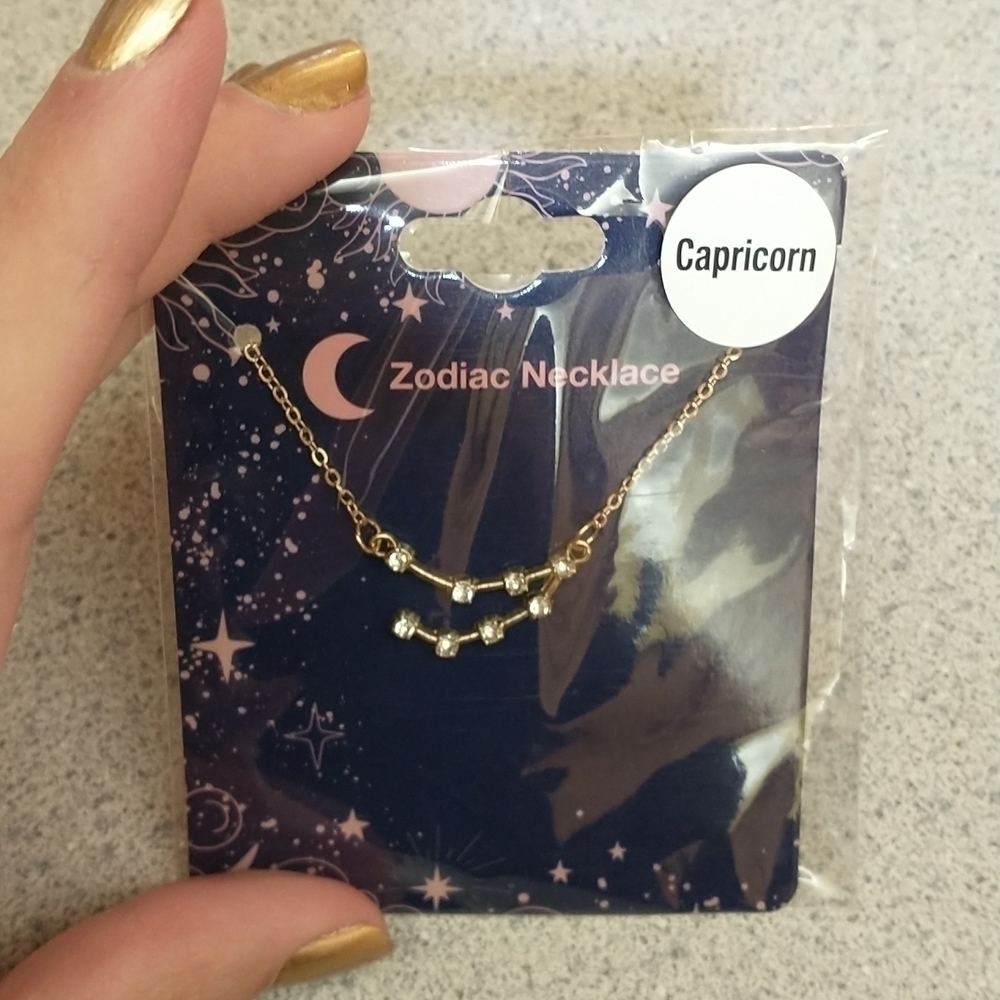 Gold tone and crystal Capricorn necklace